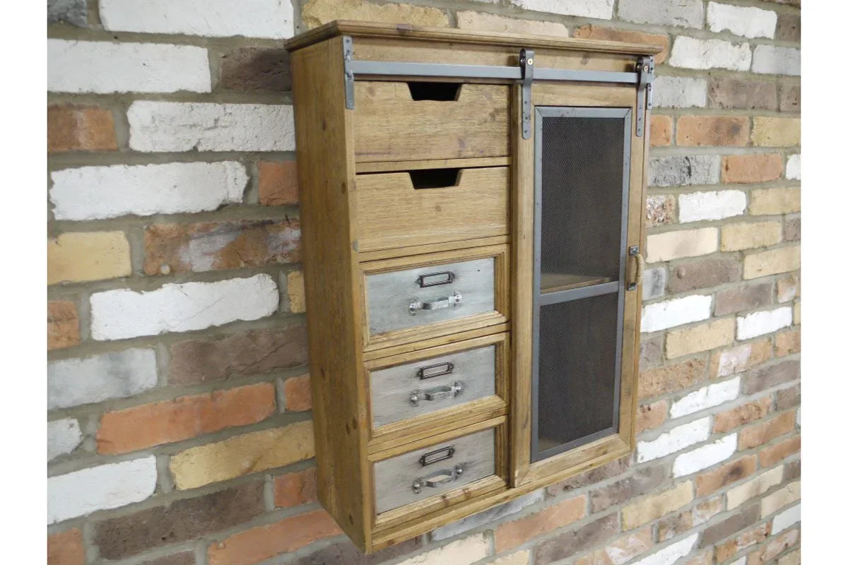 Rustic wood wall cabinet with sliding mesh door and four drawers, mounted on brick wall