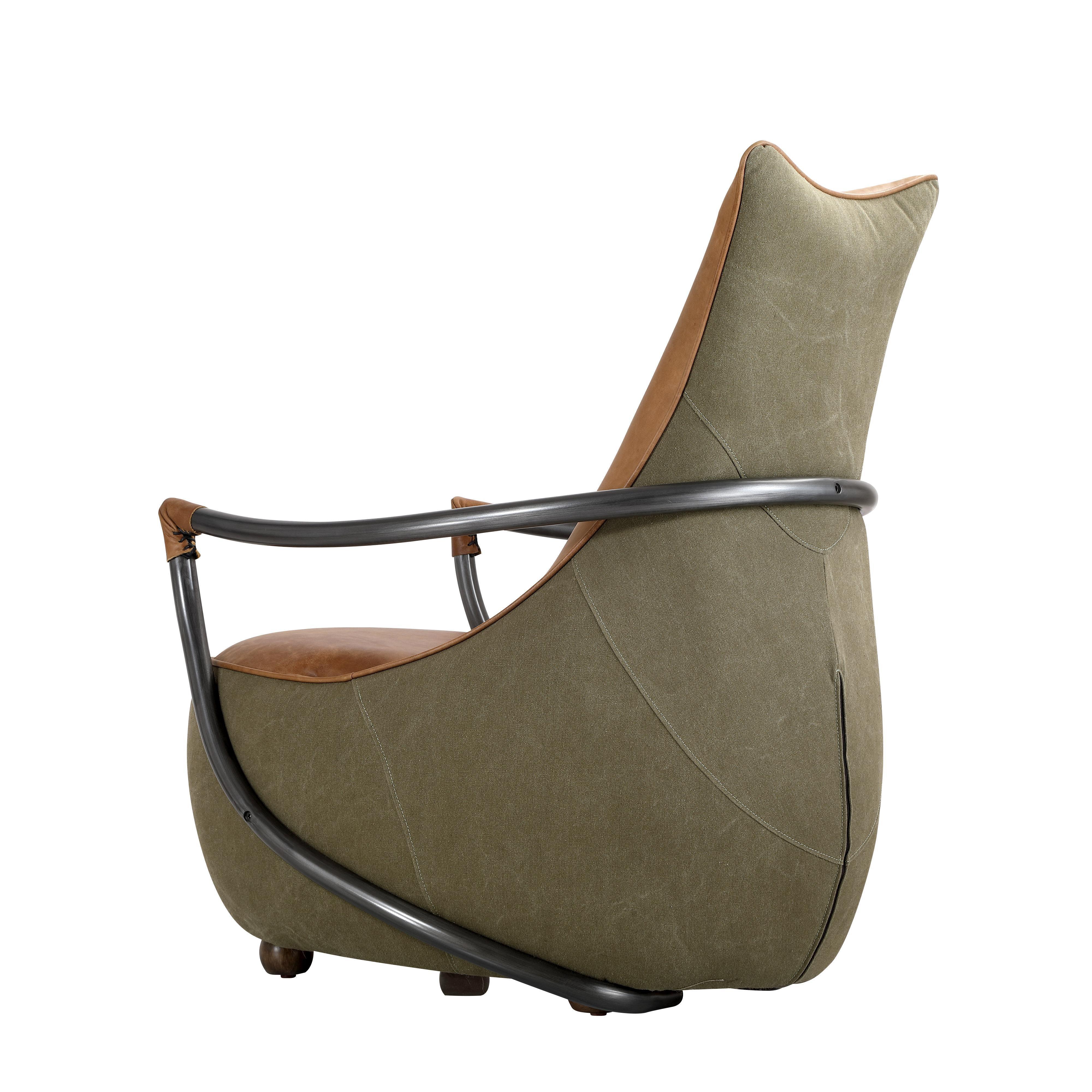 Modern accent chair with olive green upholstery, tan leather details and curved metal armrests