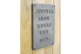 The Jupiter Industrial Wine Cabinet features a rustic wooden design with a vintage metal plaque, adding a touch of industrial charm to any space