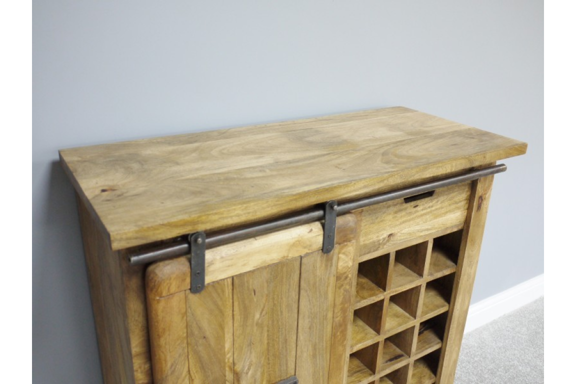 The Jupiter Industrial Wine Cabinet features a rustic wooden design with a sliding metal bar, a spacious top surface, and a grid for storing wine bottles