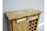 The Jupiter Industrial Wine Cabinet features a rustic wooden design with a sliding metal bar, a spacious top surface, and a grid for storing wine bottles