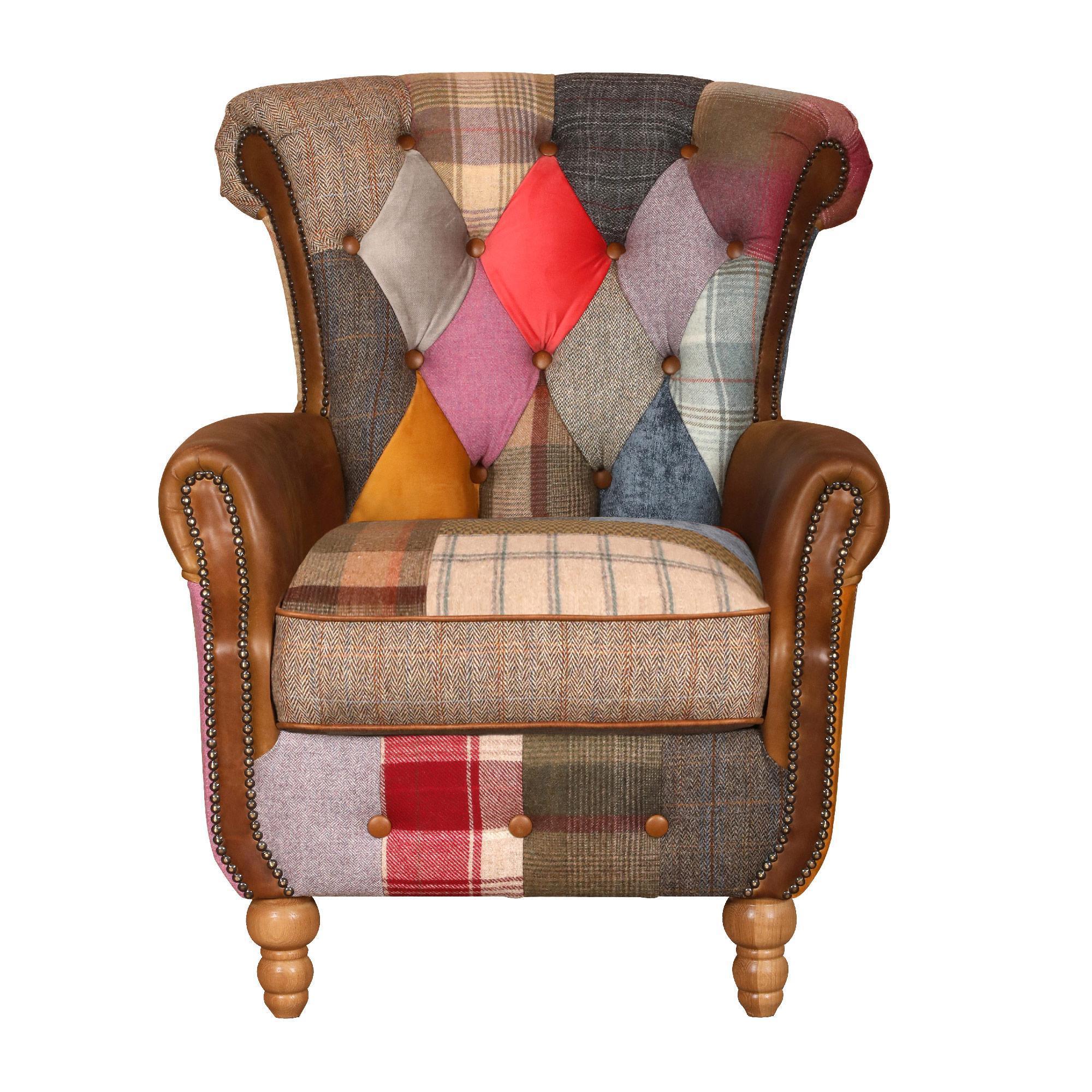 Patchwork armchair with multicoloured fabric panels, brown leather arms and wooden legs