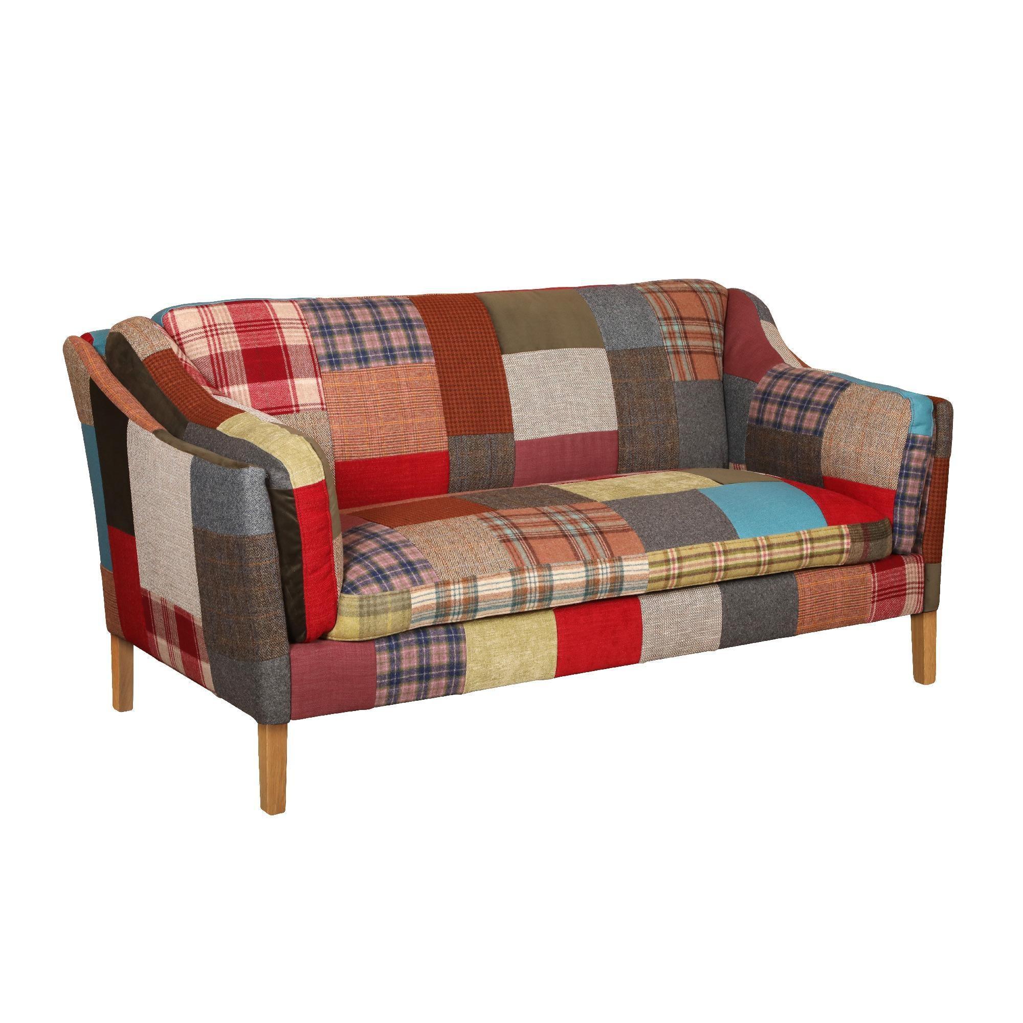 Patchwork fabric sofa with wooden legs in multi-colour patterns, front angle view
