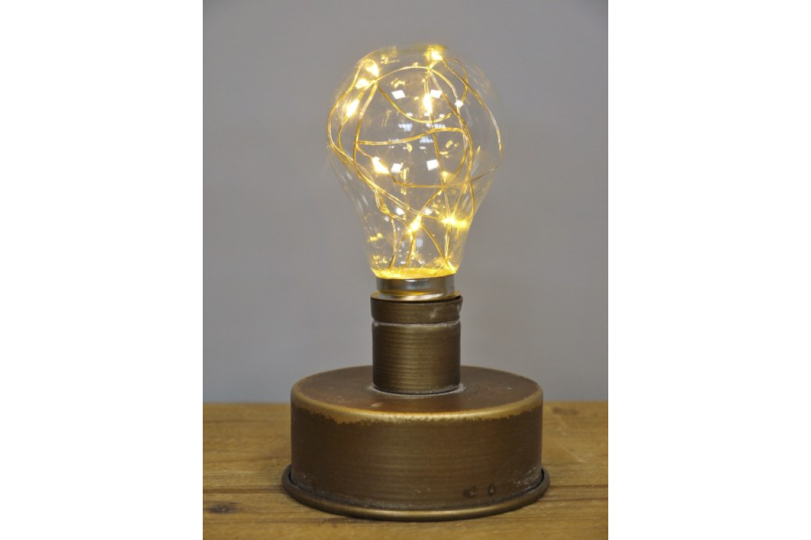 Metallic industrial-style table lamp with a round base and a light bulb filled with warm fairy lights, front view.