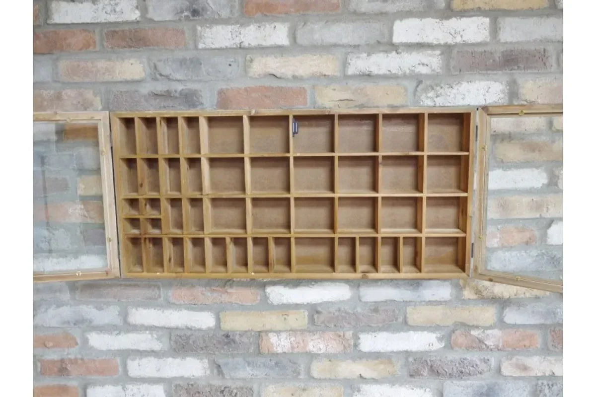 Wooden display cabinet with glass doors and multiple storage compartments on brick wall