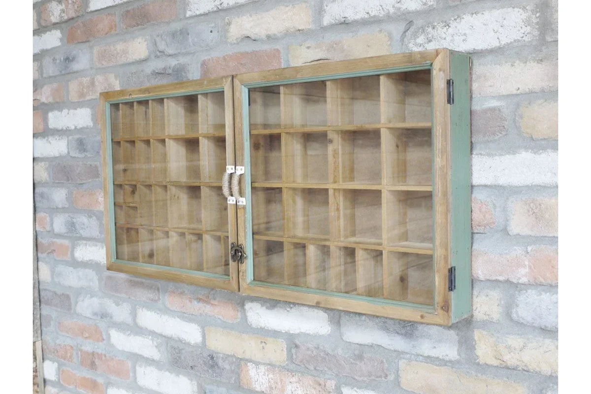 Wooden display cabinet with glass doors and multiple compartments mounted on brick wall