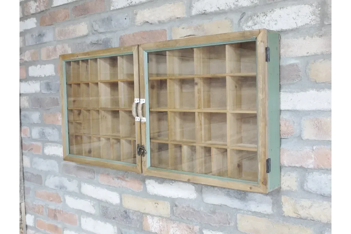 Wooden display cabinet with glass doors and grid shelves mounted on brick wall