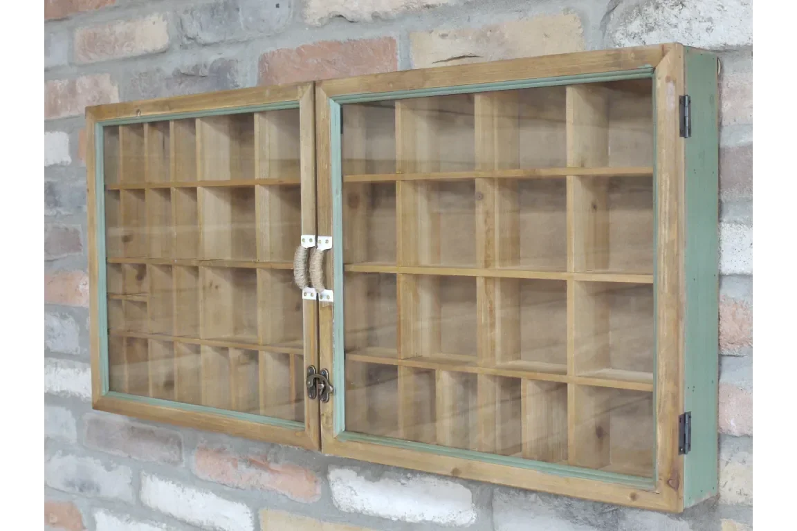 Wooden display cabinet with glass doors and multiple compartments on brick wall