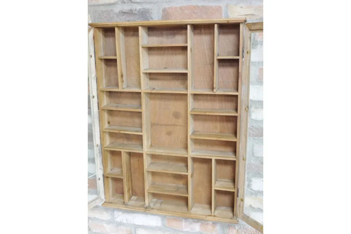 Wooden wall display shelf with multiple compartments against exposed brick wall
