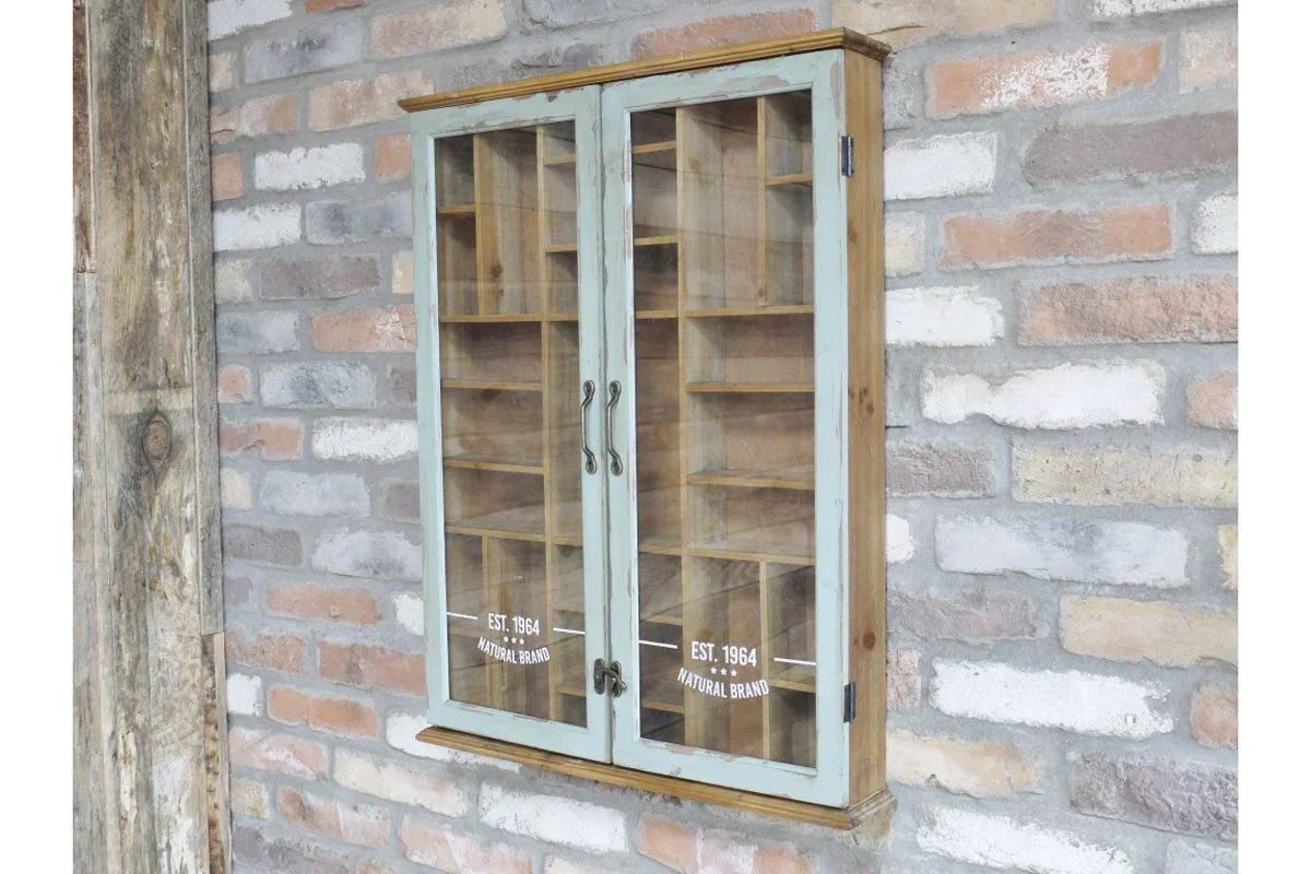 Rustic wooden display cabinet with glass doors and shelves mounted on a brick wall