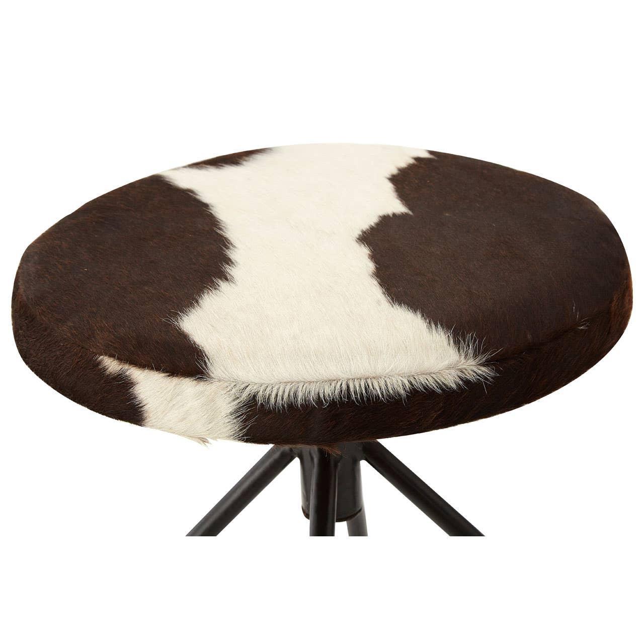 Round cowhide stool seat with black and white pattern on metal tripod base