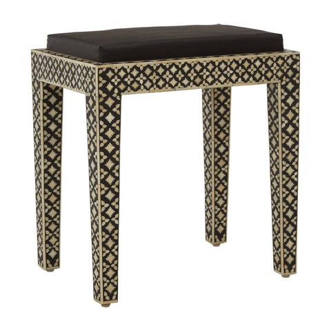 Boho black stool featuring a cushioned top and intricately designed legs with mother of pearl inlay, showcasing a geometric pattern. The stool has a sleek, modern silhouette that complements various decor styles