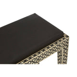 Black stool featuring a smooth top and intricately designed legs adorned with mother of pearl inlay, showcasing a bohemian aesthetic. The stool's geometric patterns add a touch of elegance to its overall design