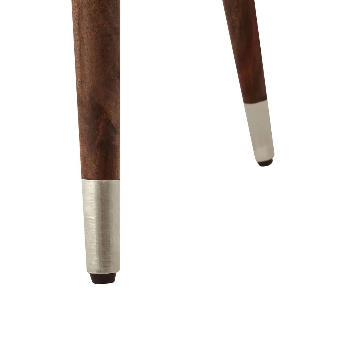 Dark wood furniture legs with silver metal tips, close-up on tapered table or chair leg