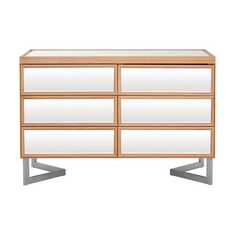 A modern six-drawer chest featuring a sleek design with a light wood finish and white drawer fronts. The chest is supported by stylish silver metal legs, providing a contemporary look suitable for various home decor styles