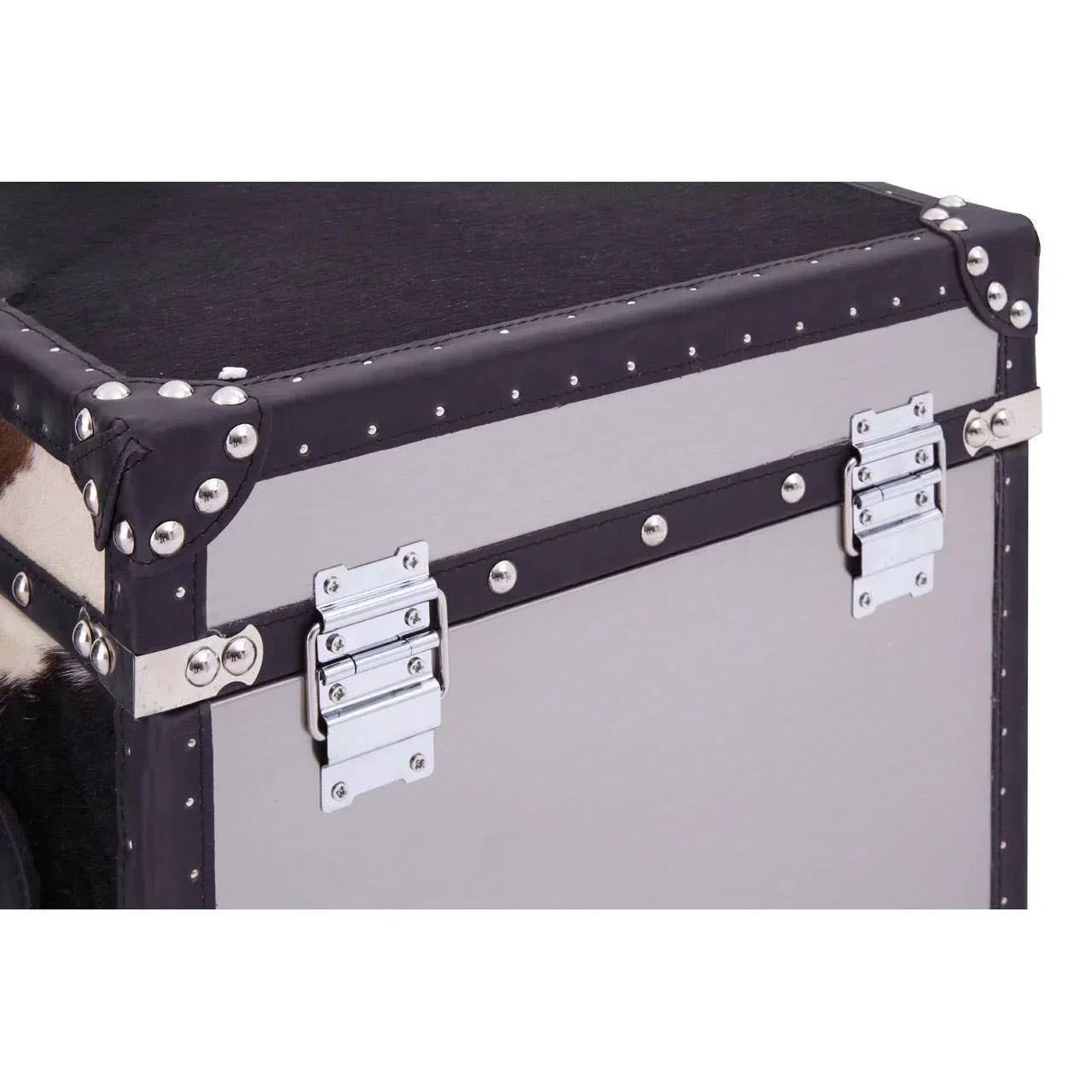Silver metal storage trunk with black leather trim and rivet detail, close-up corner view