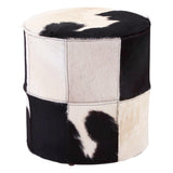 Round stool featuring a patchwork design of black and white hair-on leather, showcasing a mix of solid and patterned sections. The stool has a smooth top and a sturdy base, suitable for use as extra seating or a decorative accent in home decor