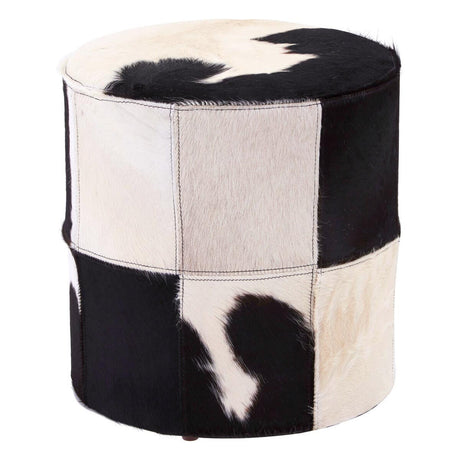 Round stool featuring a patchwork design of black and white hair-on leather, showcasing a mix of solid and patterned sections. The stool has a smooth top and a sturdy base, suitable for use as extra seating or a decorative accent in home decor