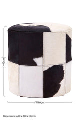 Round stool featuring a patchwork design of black and white hair-on leather, showcasing a mix of solid black and white sections. The stool has a smooth top and a sturdy base, ideal for use as extra seating or a decorative accent in home decor