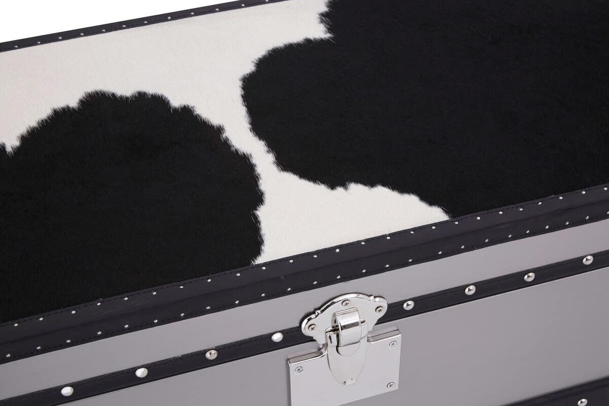 Close-up view of the Kensington Townhouse 3 Drawer Cabinet featuring a black and white hair-on-leather surface. The cabinet showcases a sleek design with three drawers, each adorned with a silver handle. The contrasting textures of the leather create a striking visual appeal, highlighting the unique patterns in the material