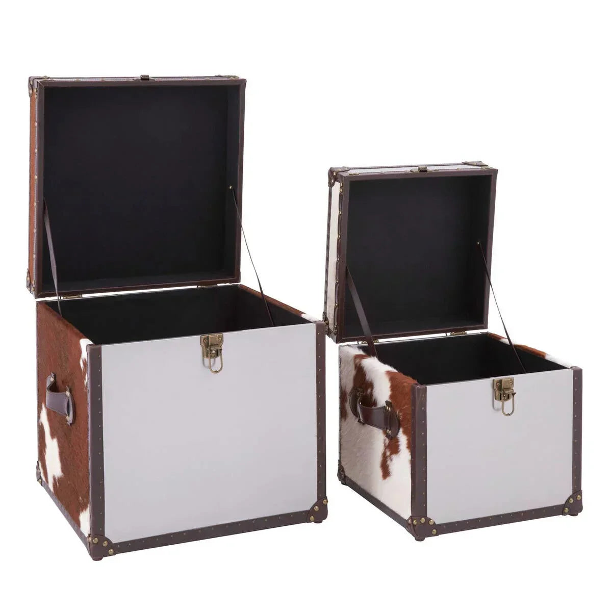 Set of two cowhide storage trunks with white panels and brown leather handles, lids open