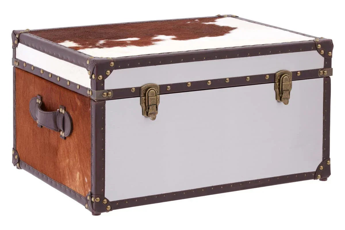 Cowhide storage trunk with brown leather trim, metal latches, and side handles