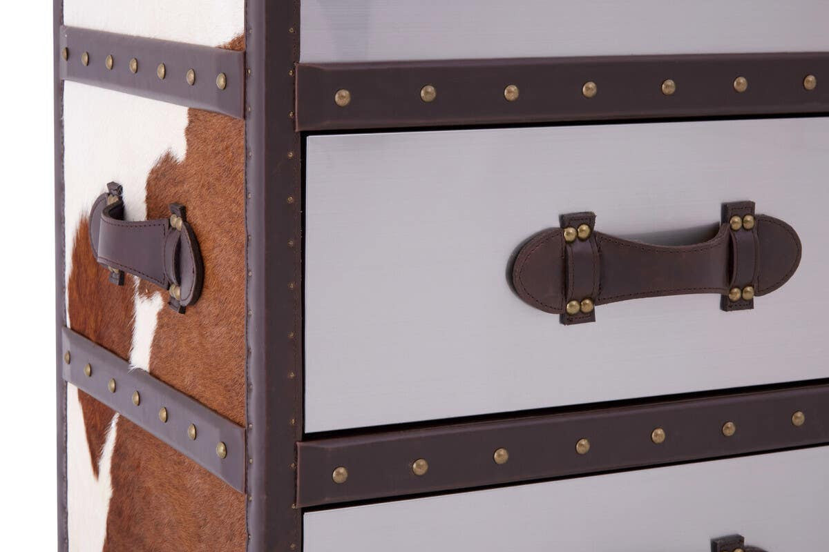 Brown and white cowhide cabinet featuring a sleek design with mirrored surfaces, decorative metal studs, and leather handles. The cabinet has three drawers, showcasing a mix of natural cowhide patterns and a polished finish