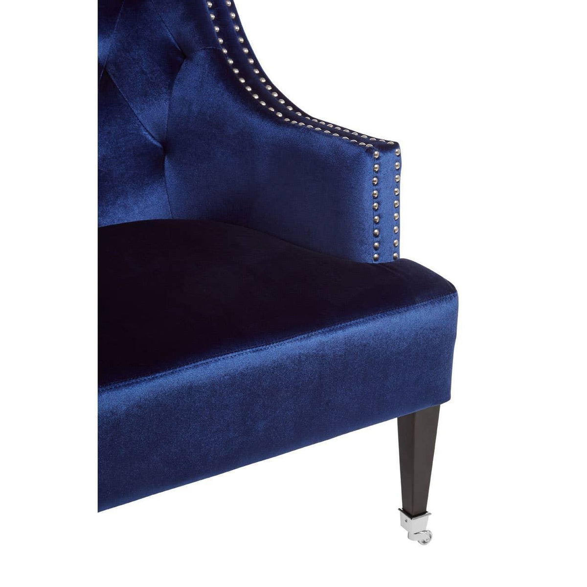 Blue velvet armchair with chrome stud detailing and black leg on castor wheel