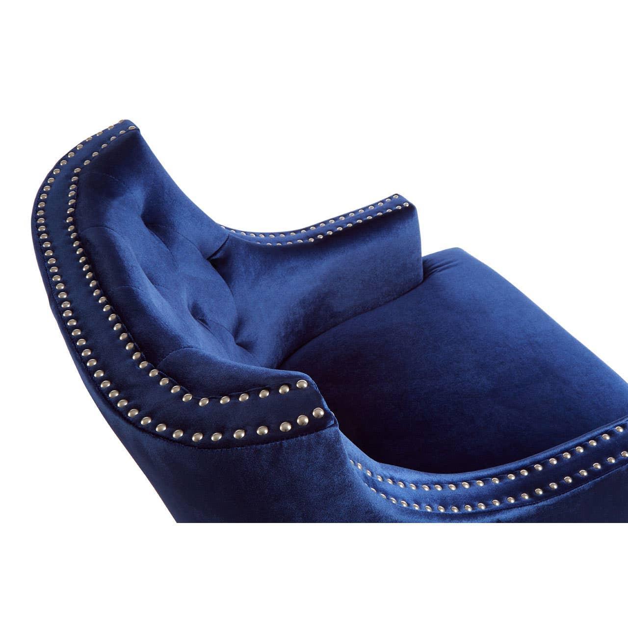 Navy blue velvet armchair with silver stud detailing and button-tufted backrest