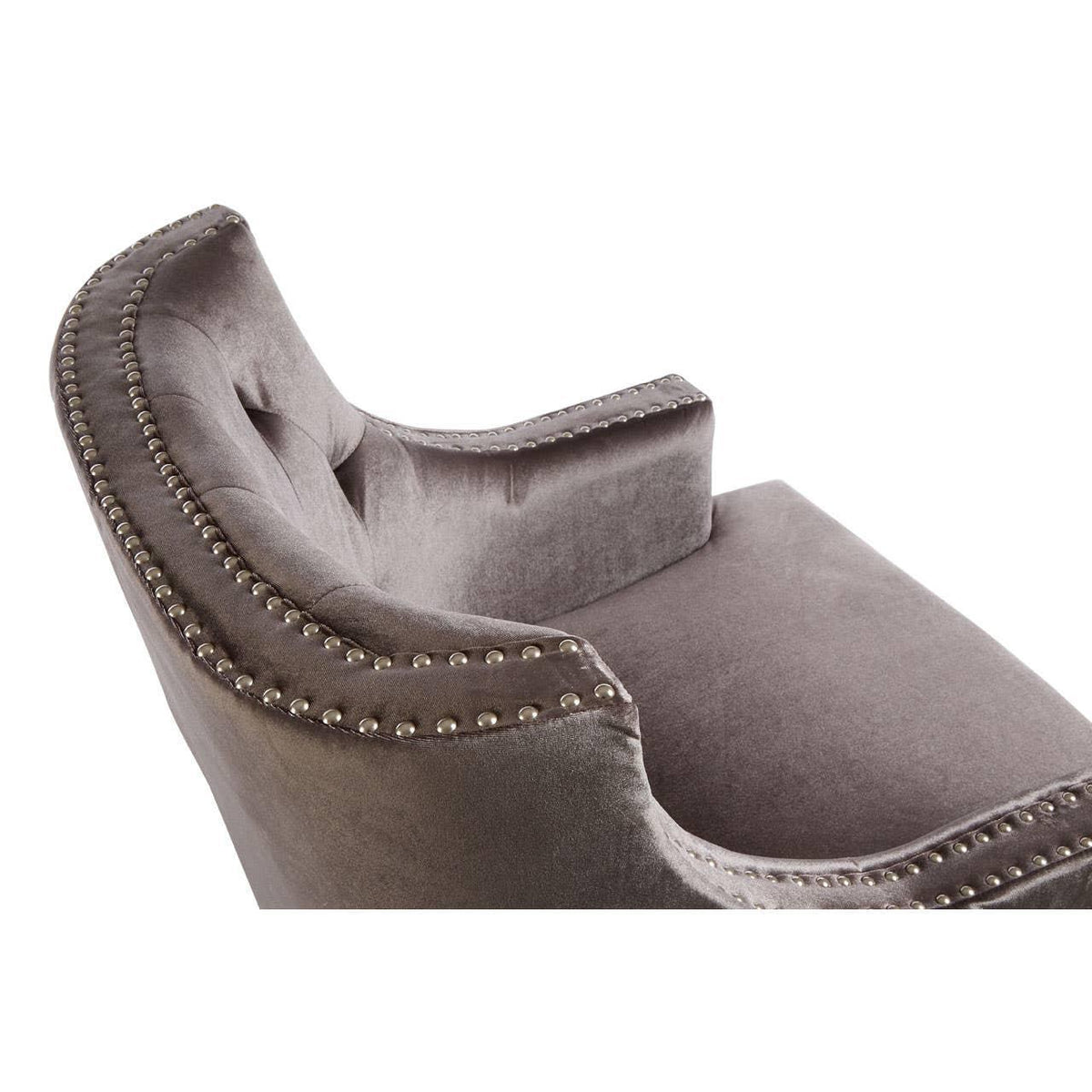 Grey velvet accent chair with silver studded trim and curved backrest close-up