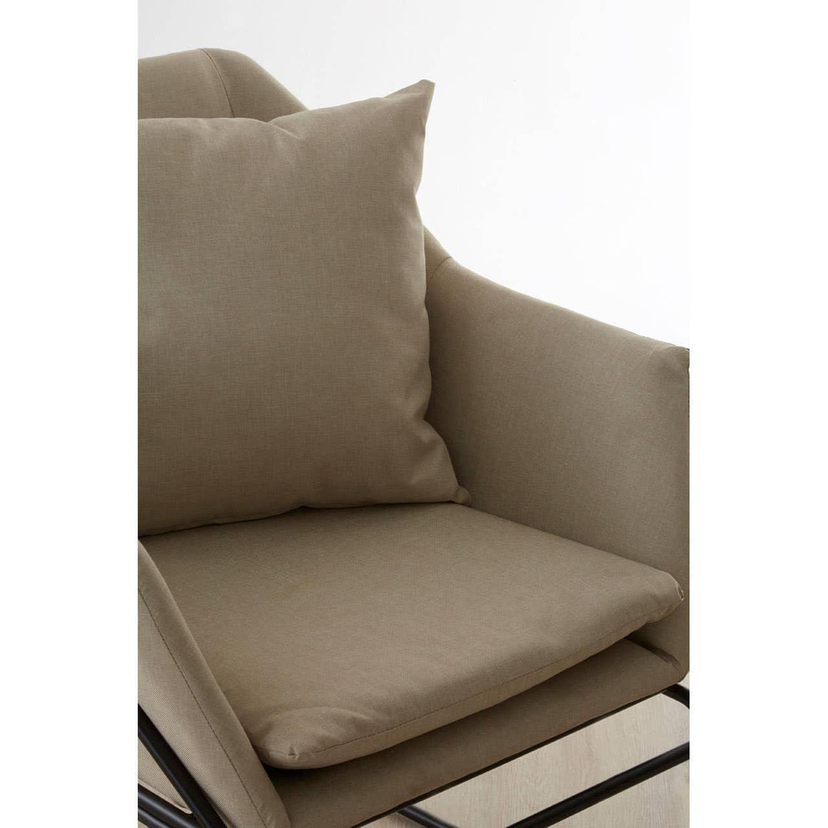 Beige fabric armchair with padded seat cushion and pillow, black metal legs visible
