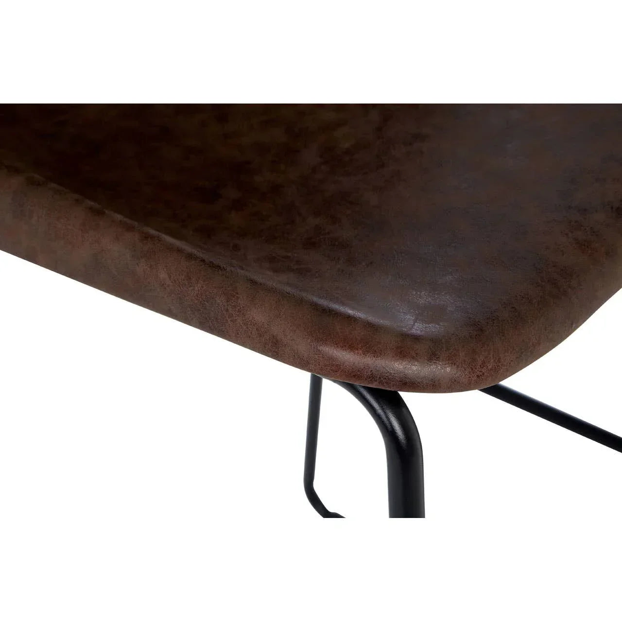 Close-up of brown faux leather dining chair seat with black metal legs