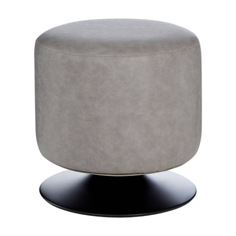 Round pouffe in ash grey faux leather with a smooth surface, resting on a circular black base. The design is modern and minimalist, suitable for various home decor styles