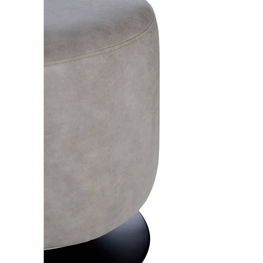 A round pouffe with a soft ash grey faux leather exterior, featuring a smooth surface and a slightly rounded top. The pouffe is supported by a sturdy black base, providing a modern and stylish accent for home decor