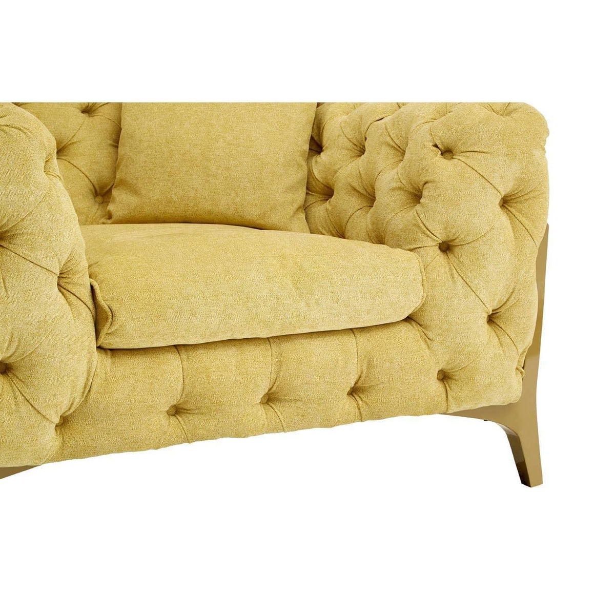 Yellow tufted fabric sofa arm with cushion and wooden leg close-up