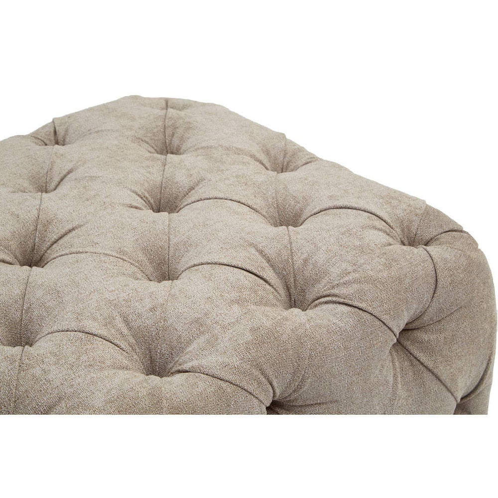 Rectangular footstool upholstered in natural fabric with a tufted design, featuring a soft, textured surface and rounded edges. The footstool is in a neutral beige color, showcasing deep button detailing for added elegance