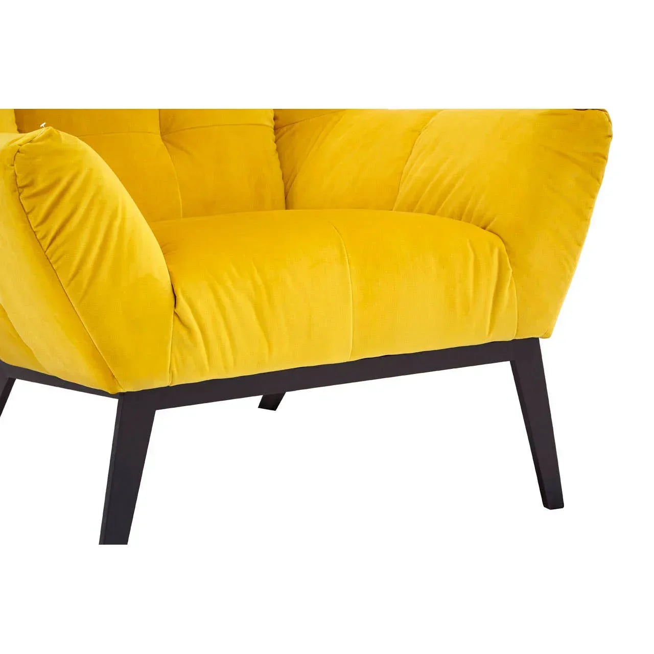 Yellow velvet armchair with black wooden legs, closeup of tufted seat and armrest
