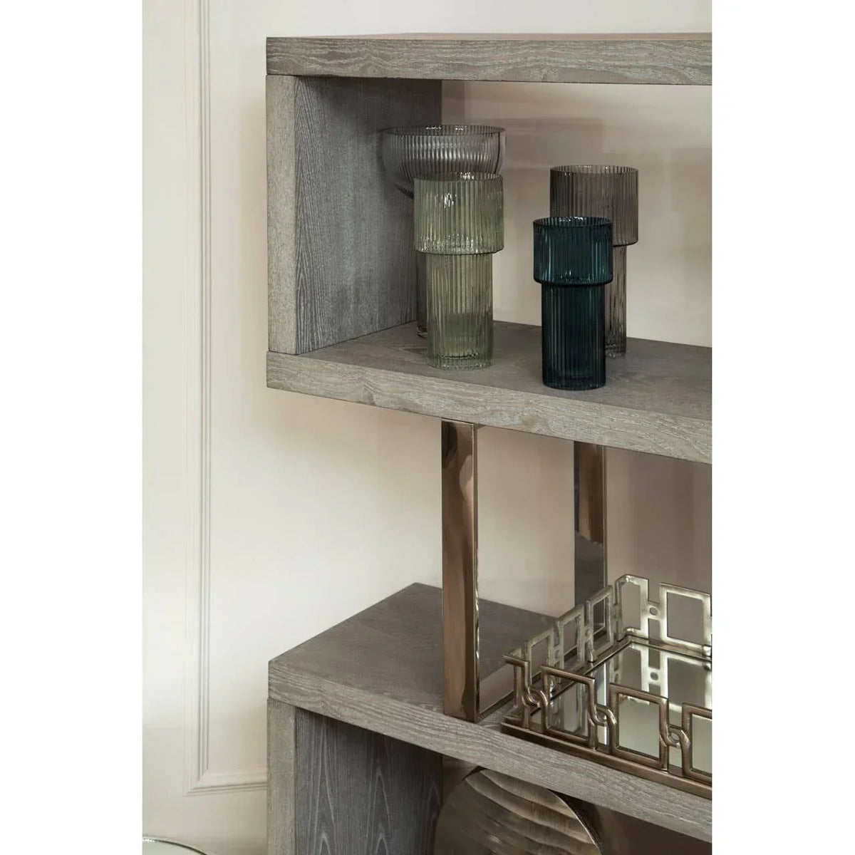 Contemporary wooden shelving unit with glass vases and decorative metal tray