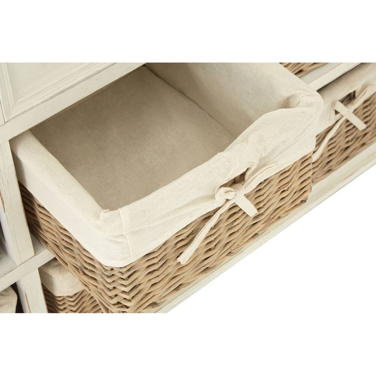 A close-up view of a willow basket from the Hendra Storage Cabinet, featuring a soft, cream-colored fabric liner and decorative ties on the front. The basket is empty, showcasing its spacious interior and woven texture