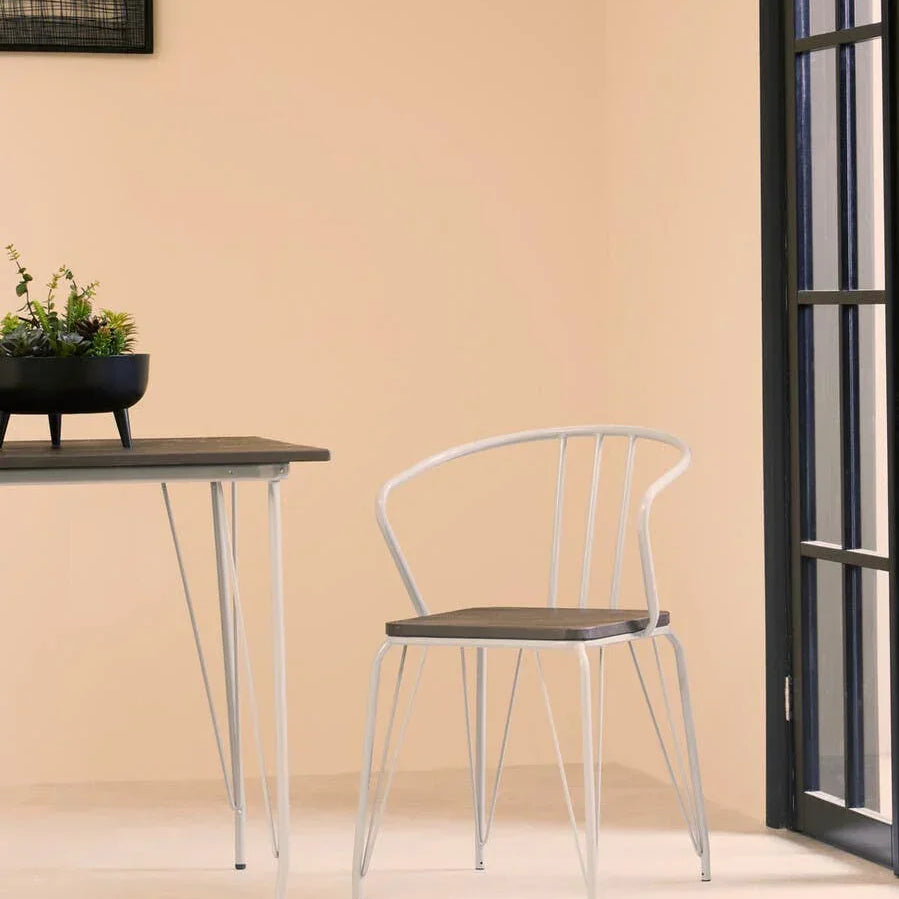 Modern dining chair with metal frame and wooden seat beside matching dining table