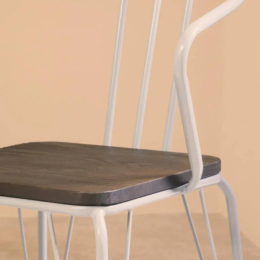 White metal dining chair with curved backrest and dark wood seat, side view