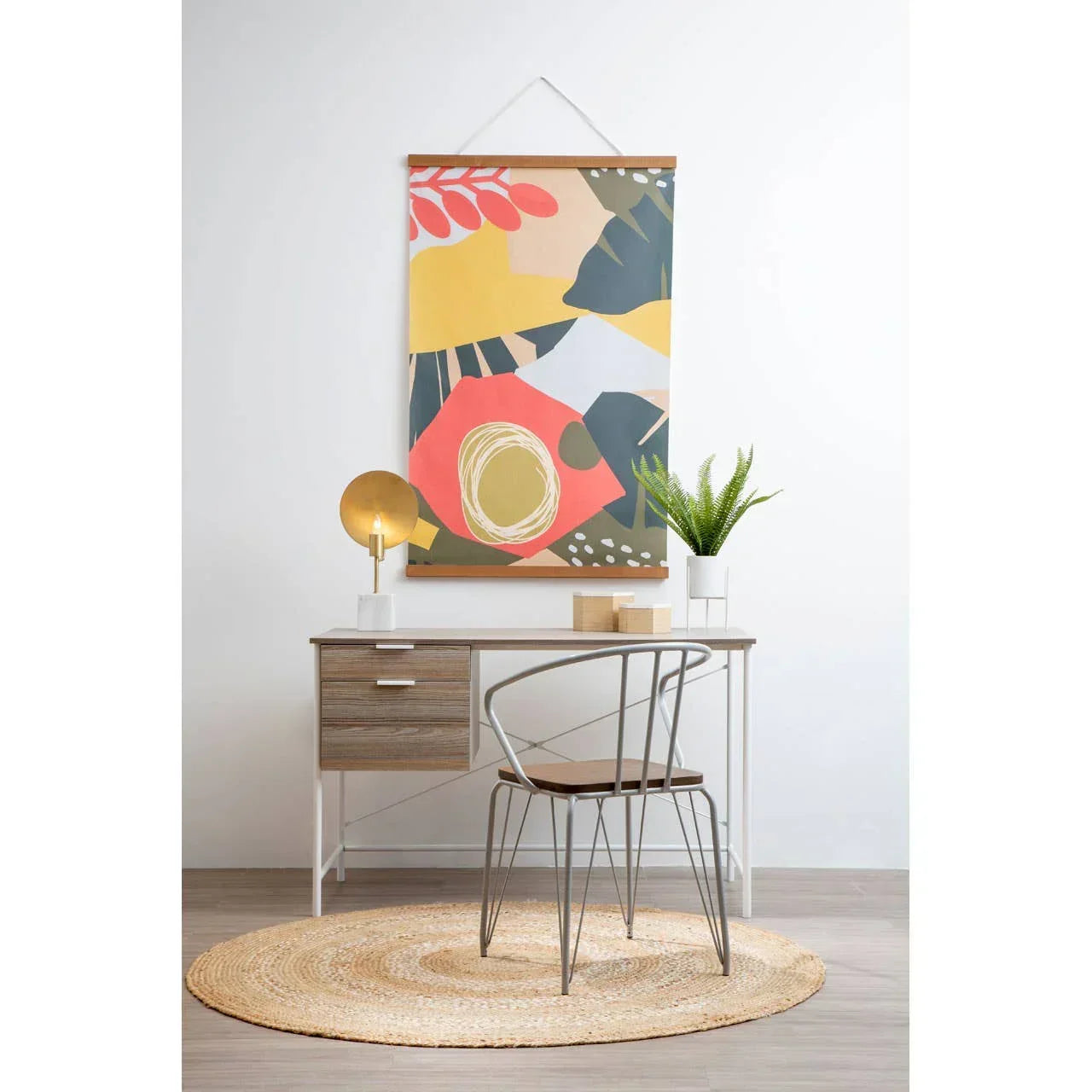 Modern wood and metal desk with chair, abstract wall art, lamp, and plant on rug