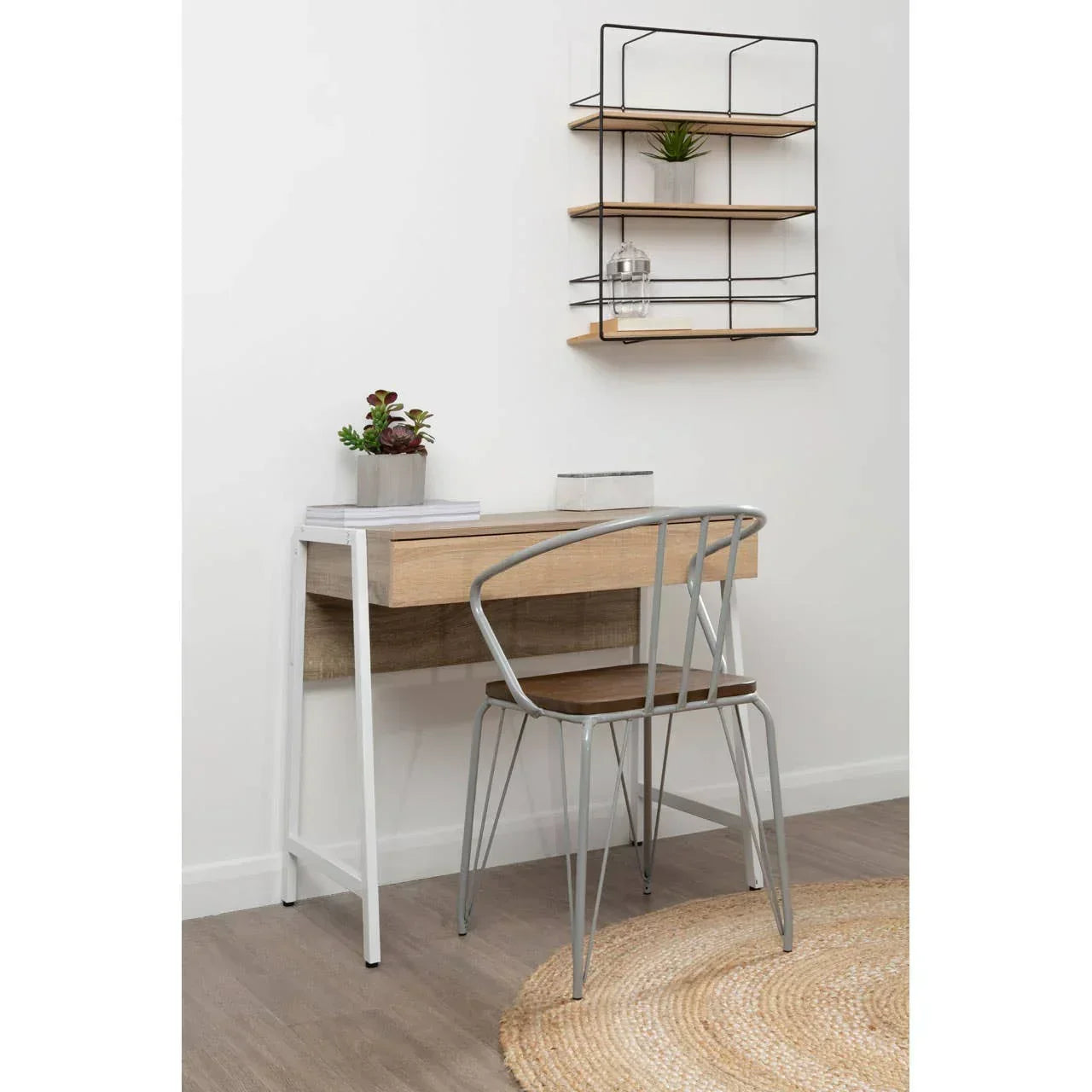 Wood and metal desk with matching chair and shelves in a minimalist home office corner