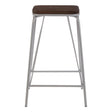 A tall stool featuring a grey metal frame and a dark brown elm wood seat, designed with clean lines and a minimalist aesthetic. The stool has a sturdy construction with a crossbar for added support