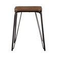 Small stool featuring a rectangular brown elm wood seat supported by a sleek black metal frame with four slender legs. The design is modern and minimalist, suitable for various home decor styles