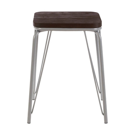 Small stool featuring a dark brown wood seat made of elm, supported by sleek grey metal legs with a modern design. The legs are angled and provide a sturdy base, while the overall look is minimalist and contemporary