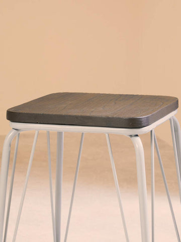 Small stool featuring a grey metal frame and a square elm wood seat, with clean lines and a minimalist design, set against a soft beige background