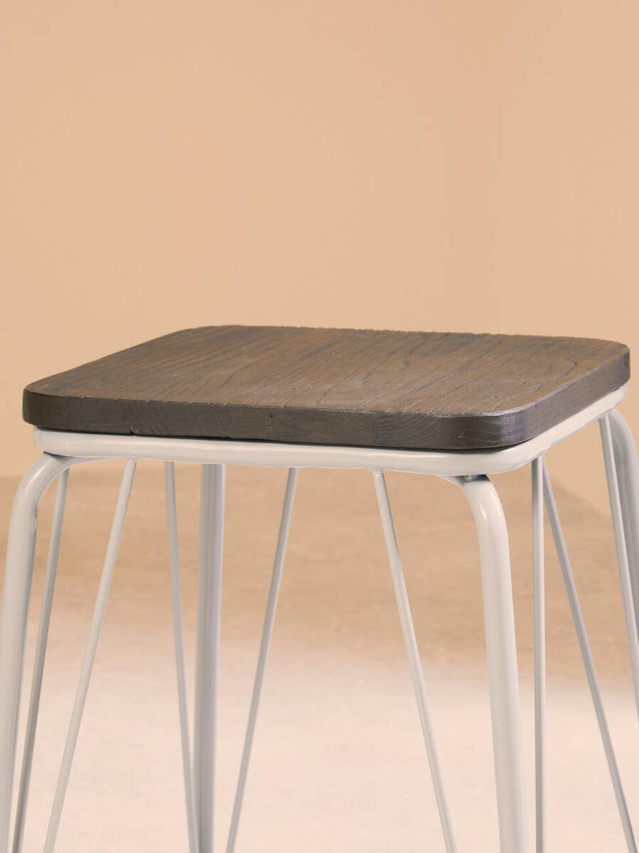 Small stool featuring a grey metal frame and a square elm wood seat, with clean lines and a minimalist design, set against a soft beige background