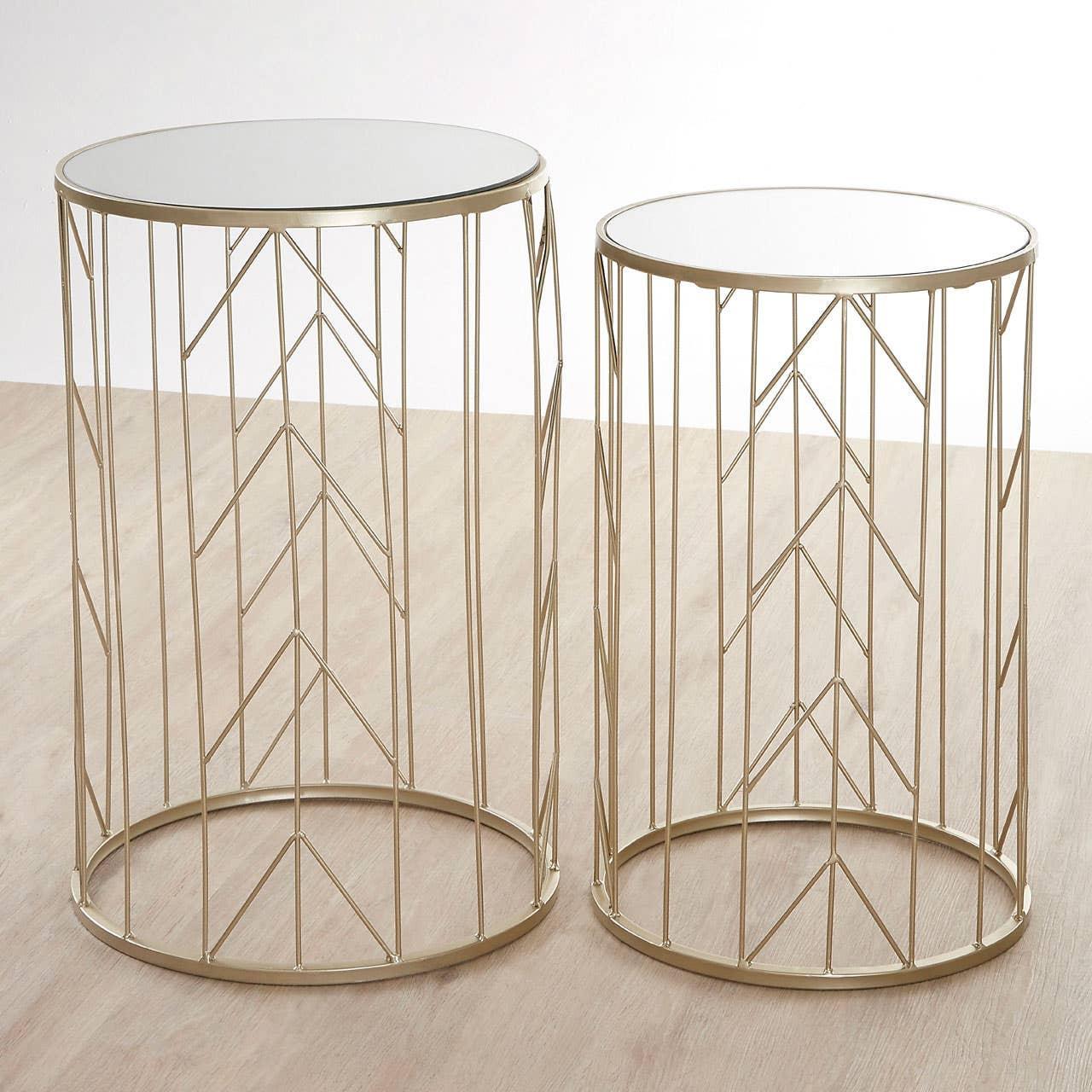 Set of two round gold metal side tables with mirrored tops on light wood floor