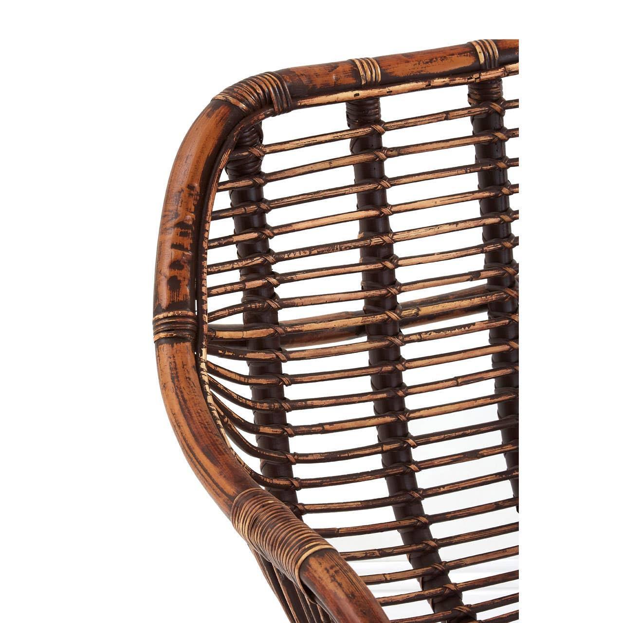 Close-up of brown rattan chair backrest with curved woven design